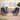3 Piece Outdoor Furniture Set Image. Cushioned Swivel Patio Chairs with Glass Top Coffee Table in an outdoor setting.