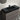 Black sink, faucet and grey finish of a vanity