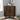 a triangular cabinet image, with two doors and metal legs in a dark brown finish