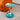 Round Pedestal Side Table Image. Modern Side table in green and gold with mermaid tail base and tray style top in a living space.