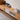 an up-close view of a wood tv stand image, featuring a 32cm width