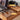 a cherry wood desk with tempered glass top and cable management