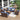 8 Piece Patio Set Image. Sectional 8 piece outdoor furniture set with Blue Cushioned Wicker Rattan Rocking Chair and Storage Table in an outdoor setting