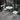 3 Piece Patio Bistro Set Image. 3 piece outdoor furniture set with Foldable Round Table and Chairs in white in an outdoor setting.