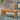 Acacia wood outdoor coffee table on geometric blue rug with patio chair