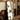 Full-length mirror with cherry wood frame reflecting indoor plant