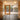Modern wood and glass entryway with slate flooring, featuring two 8-inch round acrylic flush mount ceiling lights with textured interior shades and brass canopies.