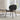 Modern black leather lounge chair in bright living room with wood floors