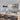 Modern gold linear crystal chandelier with 8 G9 bulbs elegantly illuminating a bright white kitchen with patterned tile backsplash and wood-accented island.