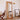 Organic shape full body mirror in natural pine frame beside floor lamp and newspaper art