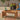Outdoor acacia coffee table with drinks and fruit tray on floral patio rug