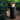 Outdoor bioethanol fire column with black stone base in garden