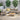 Outdoor sectional sofa set in patio setting with faux wood tables and taupe cushions