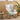Side view of retro fabric rocking chair with plant and decor in background