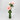 Tall green vase styled with pink florals for modern decor