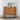Walnut buffet cabinet styled in a bright room with framed art and vase