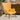 Mid-century modern yellow lounge chair staged in living room with white rug and wood cabinet