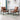 2 piece brown chair in a living room with a glass end table 