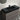 Black sink, faucet and grey finish of a vanity 