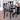 A black dining table and chairs looking elegant in a dining room.