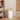 A compact swing trash bin with a smooth white finish and natural wooden lid