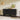 Minimalist Sideboard Image. A black sideboard with 2 Beveled Drawers, 2 cabinets, and Cord Management Cutout in a living space.