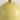 Close up view of ceramic table lamp showing smooth surface of round yellow base 