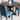 Black Round Dining Table for 4 in a Modern Dining Setting Highlighting the Cross Buck Pedestal Base and Nailhead Design