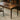 A black wood desk with a warm walnut tone and practical storage, perfect for home or office.