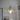 Illuminated ceiling mounted clear glass pendant light showing, clear glass floral lamp shade and brass lamp holder in gold finish