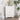 White cabinet in a bright corner with minimalist decor and wooden flooring.