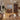 a wooden extendable dining table and chairs placed in a corner of the living room