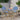 3 piece bistro set Image. 3 Piece Outdoor Furniture set in Dark Teal and Dotted White with Aluminum Frame in outdoor setting. 