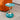 Round Pedestal Side Table Image. Modern Side table in green and gold with mermaid tail base and tray style top in a living space.