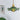 Ceiling mounted green glass pendant light showing floral lamp shade and brass lamp holder