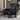 Side view of black leather accent chair with tuft design in a comfy home office setting