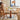 A Wood Pedestal Dining Table with Matching Wooden Dining Chairs