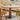 A Wood Pedestal Dining Table with White Stone Top and Matching Dining Chairs