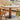 A Wood Pedestal Dining Table with White Stone Top and Matching Dining Chairs