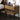 Mid Century Modern Nightstand Image. Rectangle nightstand with black legs by the bedside.