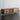 Side view of a mid century modern TV stand image, in a living area 