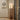 Mid Century Modern floor lamp in walnut color beautifully illuminating a living room corner 