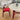 a solid wood dining room table with sintered stone top and a red dining chair