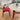 a solid wood dining room table with sintered stone top and a red dining chair