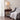 Traditional Nightstand Image. Wood nightstand in morocco brown with single drawer, open shelf and turned legs by a single sofa