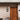 Outdoor Wall light fixture turned on and mounted by the entryway 