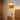 An illuminated Oak mushroom plug in Wall lamp mounted by the bed side