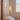 A pair of turned on plug in wall sconce installed by the bedside