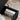 Black Leather Storage Bench Image. An upholstered storage bench showcasing its spacious interior