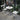 3 Piece Patio Bistro Set Image. 3 piece outdoor furniture set with Foldable Round Table and Chairs in white in an outdoor setting.